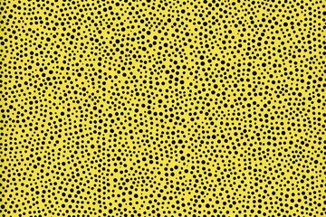 a close up of a yellow and black spotted animal skin