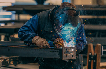Welder, craftsman, assembly of iron, steel and other metals. Industrial steel welding technician in factory, construction professionals.