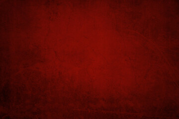 Red textured concrete grunge wall background. Dark edges
