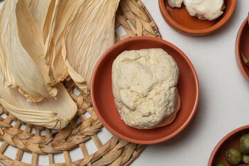 Corn husk, dough, and other ingredients preparing for tamales making