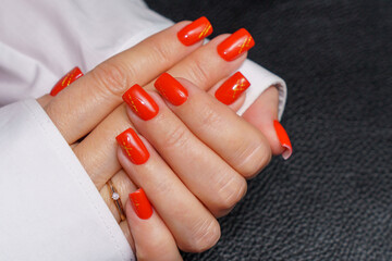 women's hands with red manicure