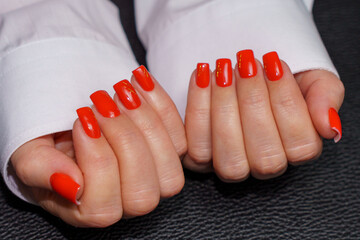 women's hands with red manicure