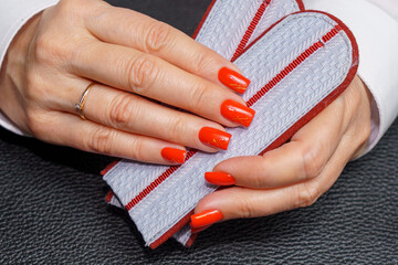 women's hands with red manicure