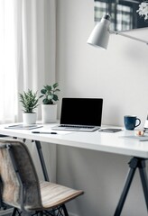 Fototapeta premium Minimalist home office setup with laptop, plants, and desk lamp. Clean white workspace for remote work, freelancing, or studying. Modern interior design with copy space