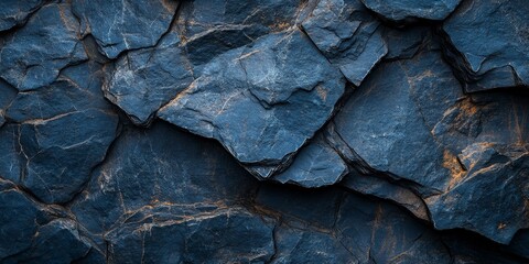 Close-up texture of dark blue slate rocks, showcasing rough cracked layers. Ideal for backgrounds, geology presentations, or design projects requiring a natural, earthy tone.