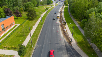 Aerial View of Road Construction with Vehicles and Greenery