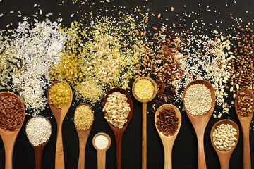 Colorful mix of grain varieties: oat and wheat, rice and millet, buckwheat and barley, quinoa and polenta. Food ingridients for healthy diet background, selective focus