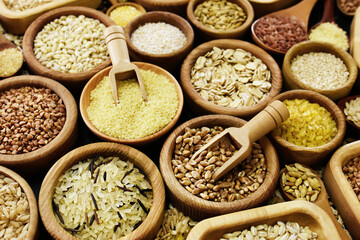 Colorful mix of grain varieties: oat and wheat, rice and millet, buckwheat and barley, quinoa and polenta. Food ingridients for healthy diet background, selective focus