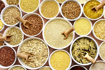 Colorful mix of grain varieties: oat and wheat, rice and millet, buckwheat and barley, quinoa and polenta. Food ingridients for healthy diet background, selective focus