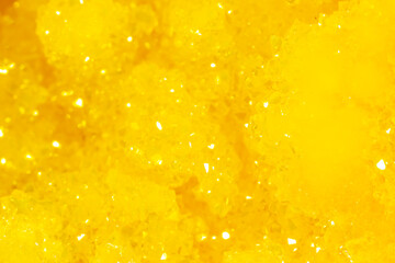 Golden crystal mineral stone. Gems. Mineral crystals in the natural environment. Texture of...