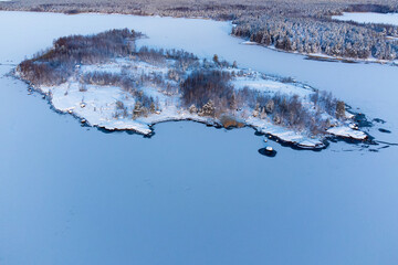 A snow-covered island in a sea covered with ice.
