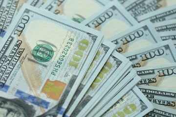 Many hundred dollar bills new banknotes in big pile under the natural light