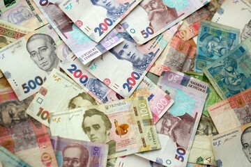 Big amount of different ukrainian hryvnia currency money bills in pile