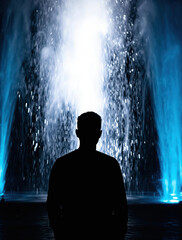 Obraz premium Minimalist Human Outline Confronting a Luminescent Waterfall Signifying Personal Solitude