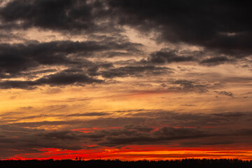 Experience the breathtaking and stunning sunset that paints the sky over a dramatic cloudy horizon