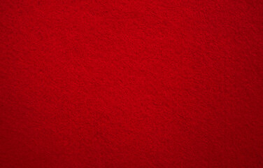 A photo of the texture of the red-colored fabric.Red felt fabric background.