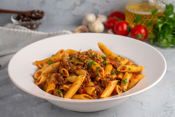 Penne pasta with minced meat and tomato sauce