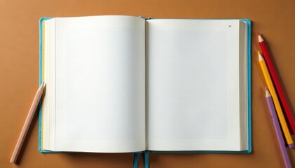 Fototapeta premium Open exercise book with pencils on brown background spread wide, study, office supplies