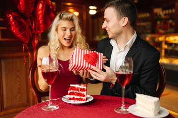 Romantic date on st. valentines day in the restaurant. Exchange of gifts.