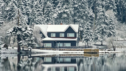 Fototapeta premium Bolu Golcuk National Park, lake wooden house on a snowy winter day in the forest in Turkey
