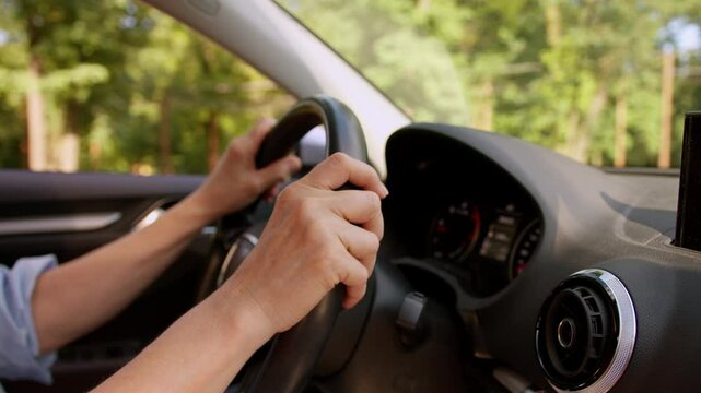 Unknown unrecognizable Caucasian senior elderly woman female hands driving steering wheel driver riding inside automobile roadtrip drive car ride auto rental vehicle leasing dashboard travelling way
