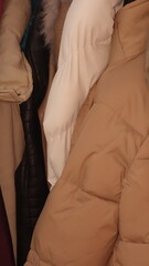 A cozy assortment of warm winter coats in various textures and colors.