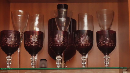 Elegant set of vintage cut glassware with intricate designs on display.