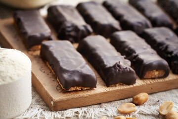 Homemade healthy bars made of whey protein powder and peanut butter, coated in chocolate