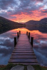 Fototapeta premium Vibrant sunset over tranquil lake with wooden dock in serene landscape