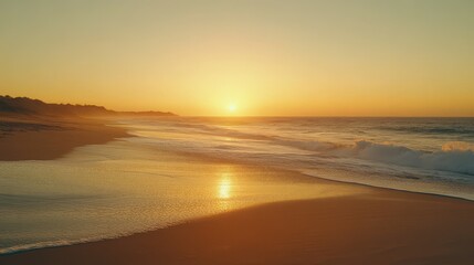 Obraz premium Vibrant sunset casts golden hues over peaceful beach and gentle waves