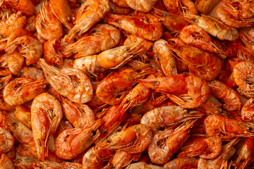Shrimp close-up in a large pile. Smoked and salted shrimp with spices for a beer snack.