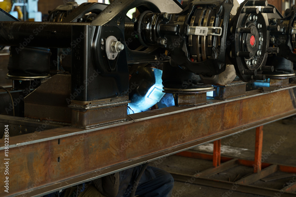 Poster welding operation on railway components in a busy manufacturing facility