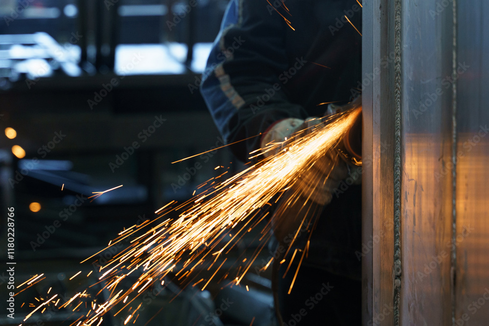 Poster sparks fly as a skilled worker performs metal grinding in a workshop
