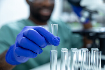 Doctor working on analysis and study of medicine and chemicals using test tubes for investigation