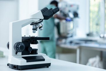 Scientist's microscope for magnifying samples and testing chemicals in lab