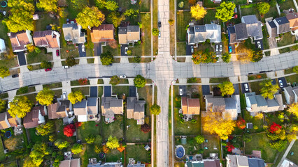 Aerial View of Suburban Neighborhood in Autumn. Top-down aerial shot of a suburban neighborhood...