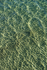 Irregular pattern on the surface of seawater above a sandy surface