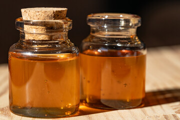 jars with honey in the sunlight on the wooden table