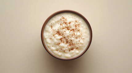 Creamy rice pudding in a bowl, sprinkled with cinnamon.