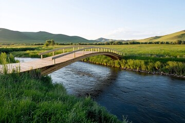 Fototapeta premium Wooden bridge over river, serene grassland, sunset