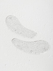 Transparent patches with glitter for eyes on white background. Drops of water