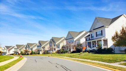 neighborhood of detached houses by the road. Modern single family homes.