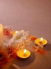 Celebration of Diwali or Deepavali holiday in India with candles and flowers in the evening at night close-up. Hindus celebrate the festival of lights, vertical