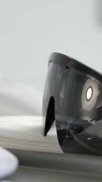 Man picks up sunglasses off office table in summer. High quality 4k footage