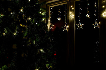 Festive Christmas Decorations With Twinkling Lights and a Beautifully Adorned Tree in a Cozy Indoor Setting
