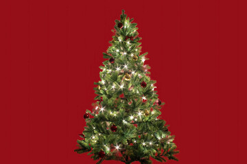 Christmas Tree Adorned With Lights and Ornaments Against a Red Background, Creating a Festive Atmosphere for the Holiday Season