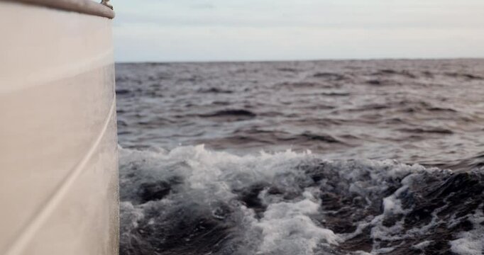 Starboard hul on a sailboat cutting trough the ocean while crossing the Bay of Biscay Stock Footage