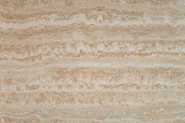 This image features a beautifully textured surface with soft beige and cream tones, showcasing natural stripes and intricate patterns reminiscent of polished stone.