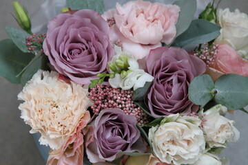 Bouquet of purple roses, carnations, eustoma, freesia and eucalyptus