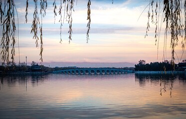 Summer Palace. Beijing stunning purple dusk with bridge and branches. China © Ignacio